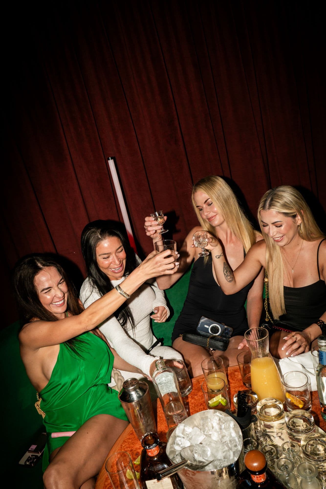 A group toasting at a reserved table at Every F*cking Friday